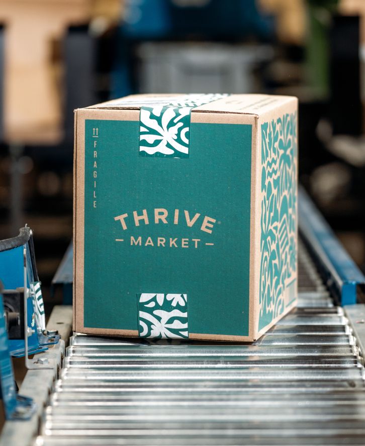 A Thrive Market box on a conveyor belt.